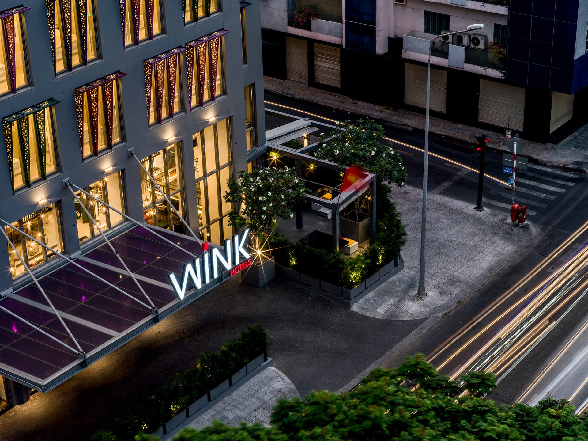 Wink Hotel exterior at dusk, District 1